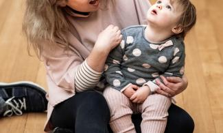 Woman and child sitting on gallery floor
