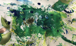 Smudged mix of blue and green paint colours on paper