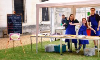 Volunteers in art activity tent on lawn of Fitzwilliam Museum