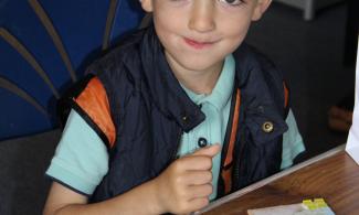 Child making Roman-style mosaic tile