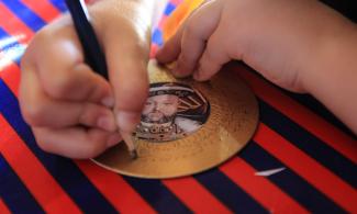 Child drawing a miniature of Henry VIII