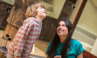 Child and museum staff member in the museum of archaeology and anthropology