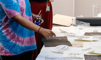 2 women look at drawings they have made