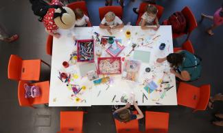 children around a table doing activities