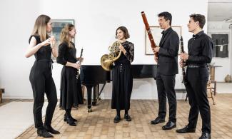 student musicians standing up with their instruments