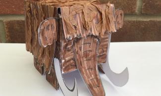 A woolly mammoth crafted from card and decorated with brown en