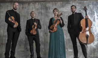 four musicians holding string instruments