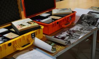 Two cases full of art materials and replica artworks, including teacher notes and full size images.