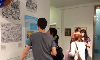 people looking at an exhibition display