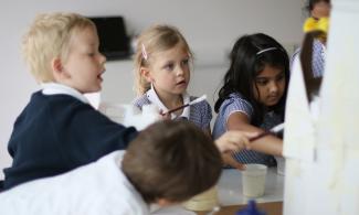 image of young students painting