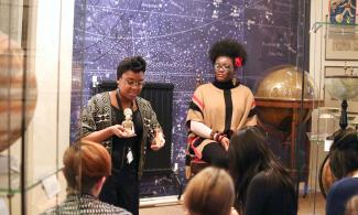 A group of people in a museum looking at an object