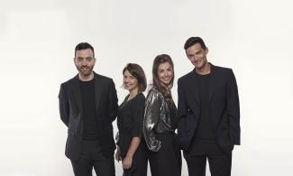 four people  smiling at the camera 