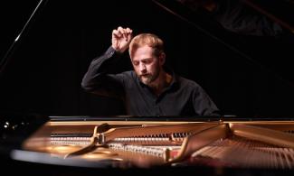 a person sitting at a piano