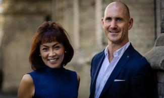 Two people smiling into the camera