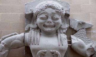 Statue of Medusa smiling with snakes for hair.
