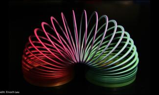 a rainbow coloured slinky toy