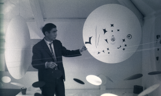 A man in front of an artwork