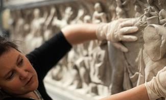 University of Cambridge Museums staff member describing a Greek frieze to partially sighted visitors