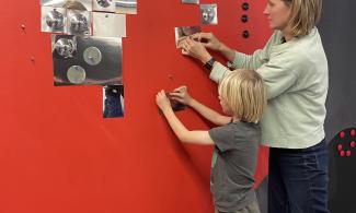 A family at a wall being creative