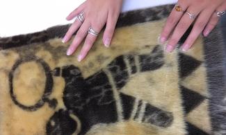 Fur art piece sewn to show the shape of a drum dancer