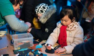 Child doing craft at event