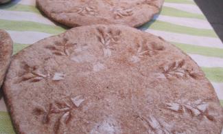 Image of bread on striped green table cloth.
