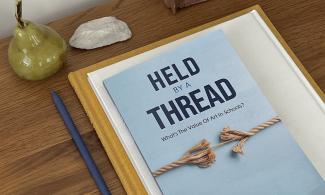 A light blue book 'Held by a Thread: What's the Value Of Art In Schools' by Anna Cutler.