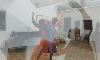 Two figures dancing in the Kettle's Yard house