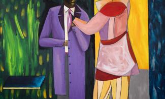 Two men dressed in bright clothing outside of a shop.