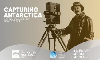 A poster with the text: Capturing Antarctica Mon 10th November 2025 18:00 - 19:00GMT. Antarctica In Sight Live. The poster has a sepia toned photograph of Herbert Ponting holding a large rectangular cinecamera. The text is white and bold. Below the image of Ponting are the logos of: UKAHT, the Scott Polar Research Institute, and the Science and Media Museum.