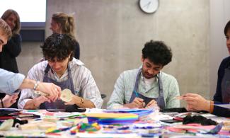 Two men participating in a creative workshop at Kettle's Yard. They are smiling.