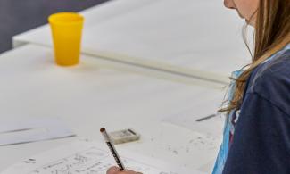 A child drawing in a workshop at Kettle's Yard.
