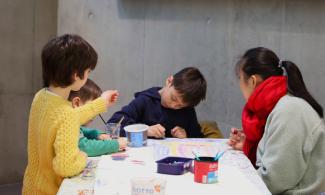 Children and families taking part in a creative workshop at Kettle's Yard.