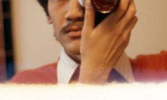 Man taking a photo with camera close to his face