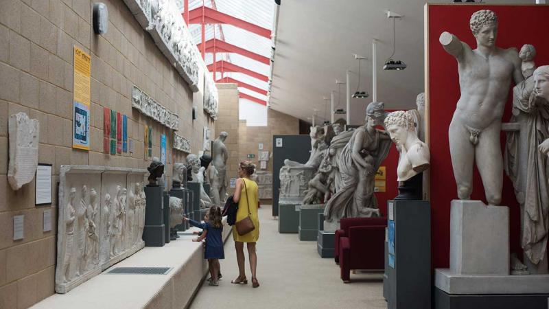 people exploring the casts inside the museum