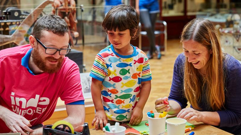 child and visitor take part in craft activities
