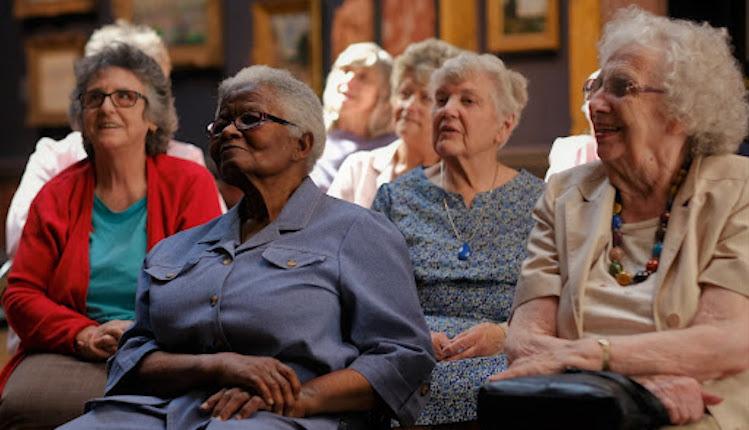 Four elderly ladies smiling