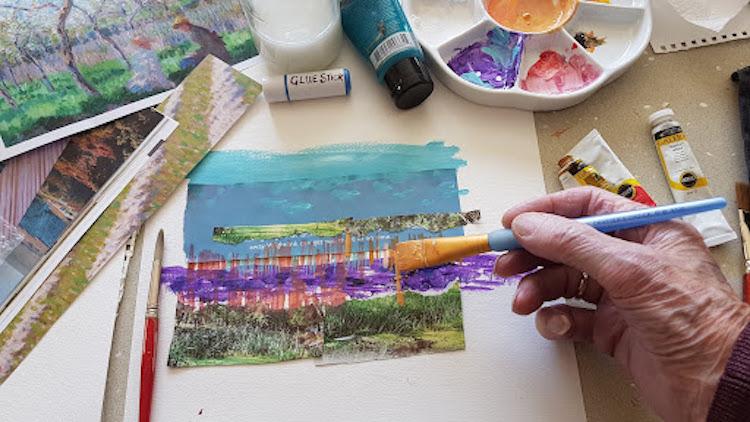 A hand holding a paintbrush doing an art activity