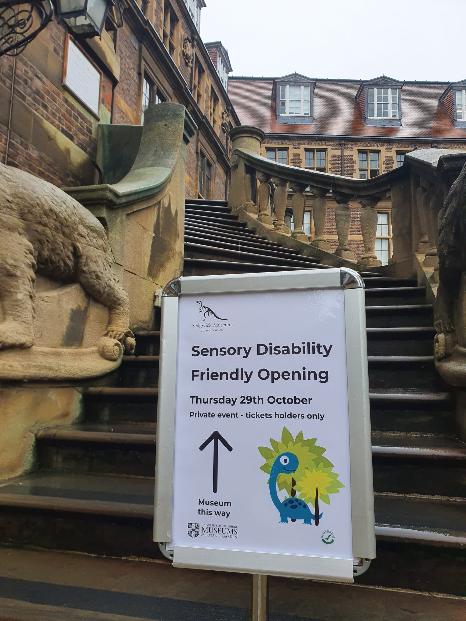 The stone steps of the Sedgwick Museum with a sign in a stand saying Sensory Disability Friendly Opening