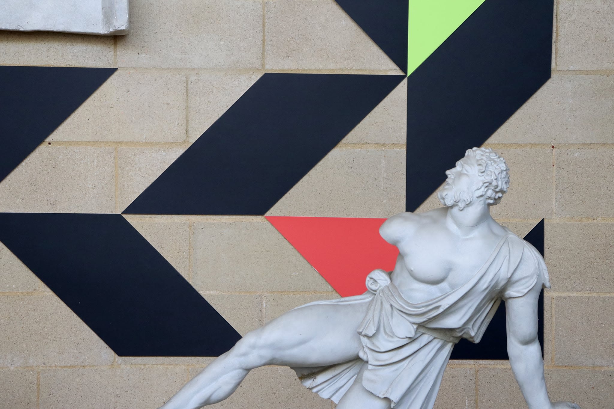 Large geometric shapes arranged behind a cast