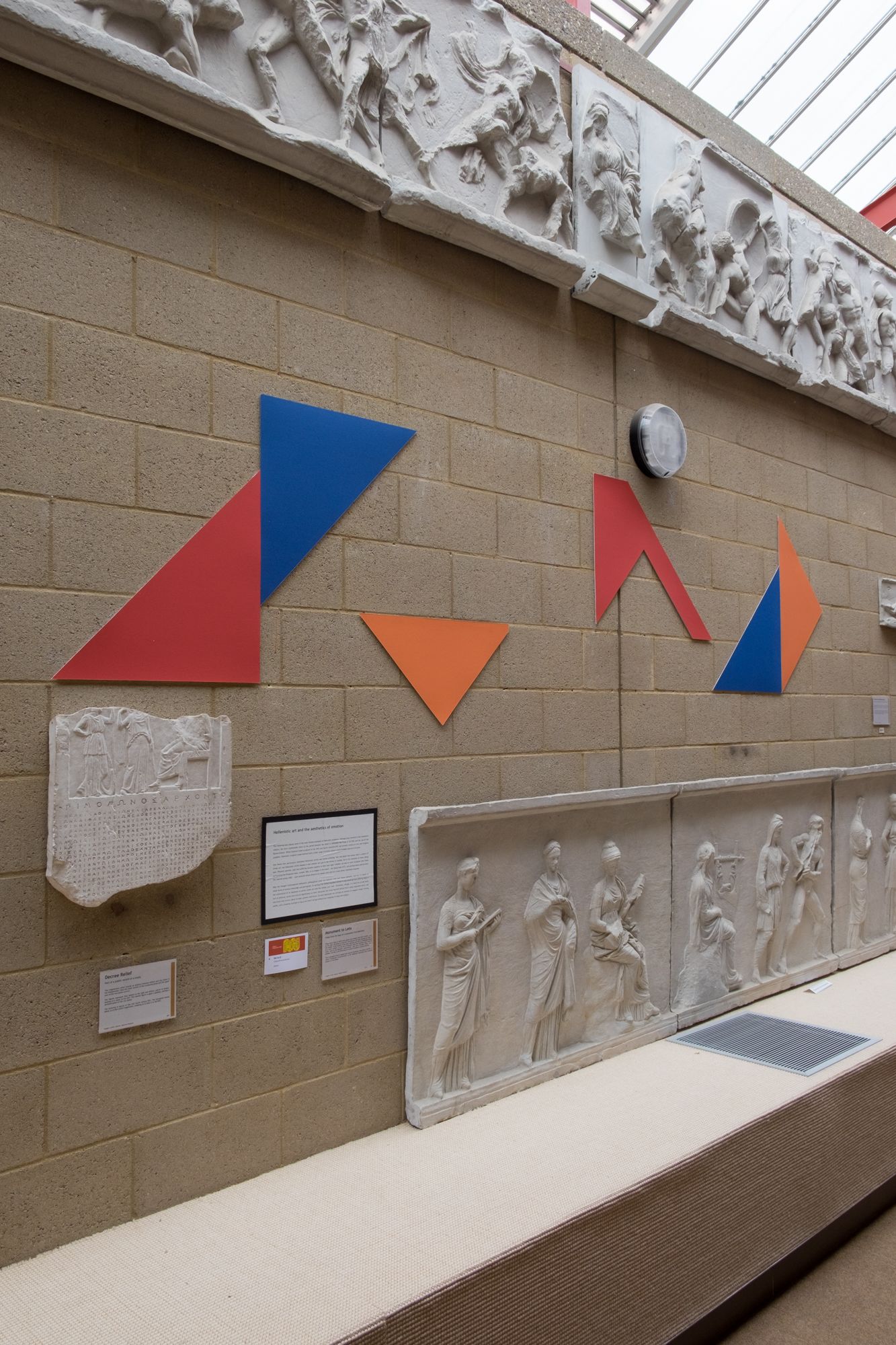 Coloured mountboard in the shape of the set square and various off cuts sit above and below casts