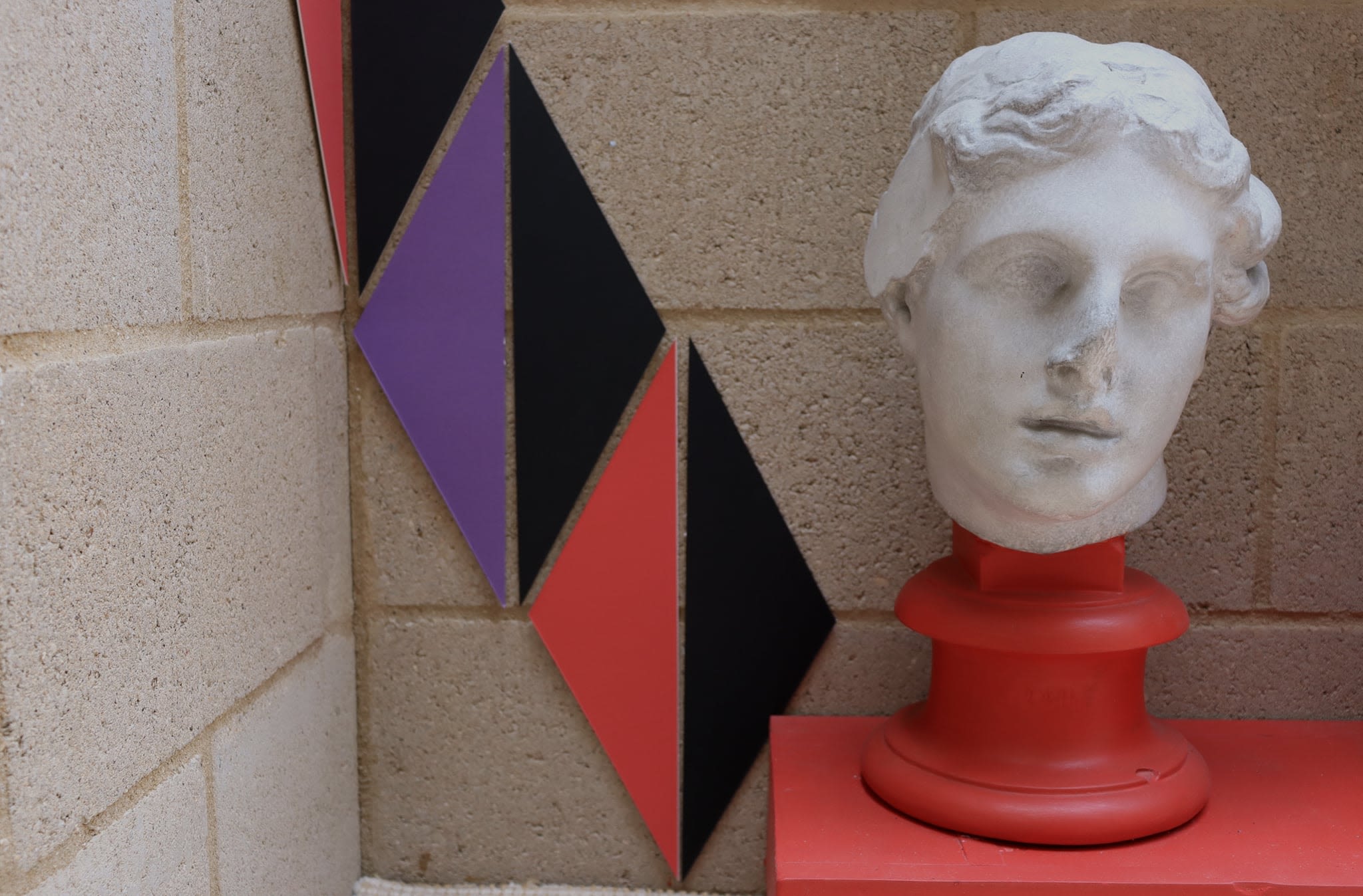 Geometric shapes arranged near a bust.