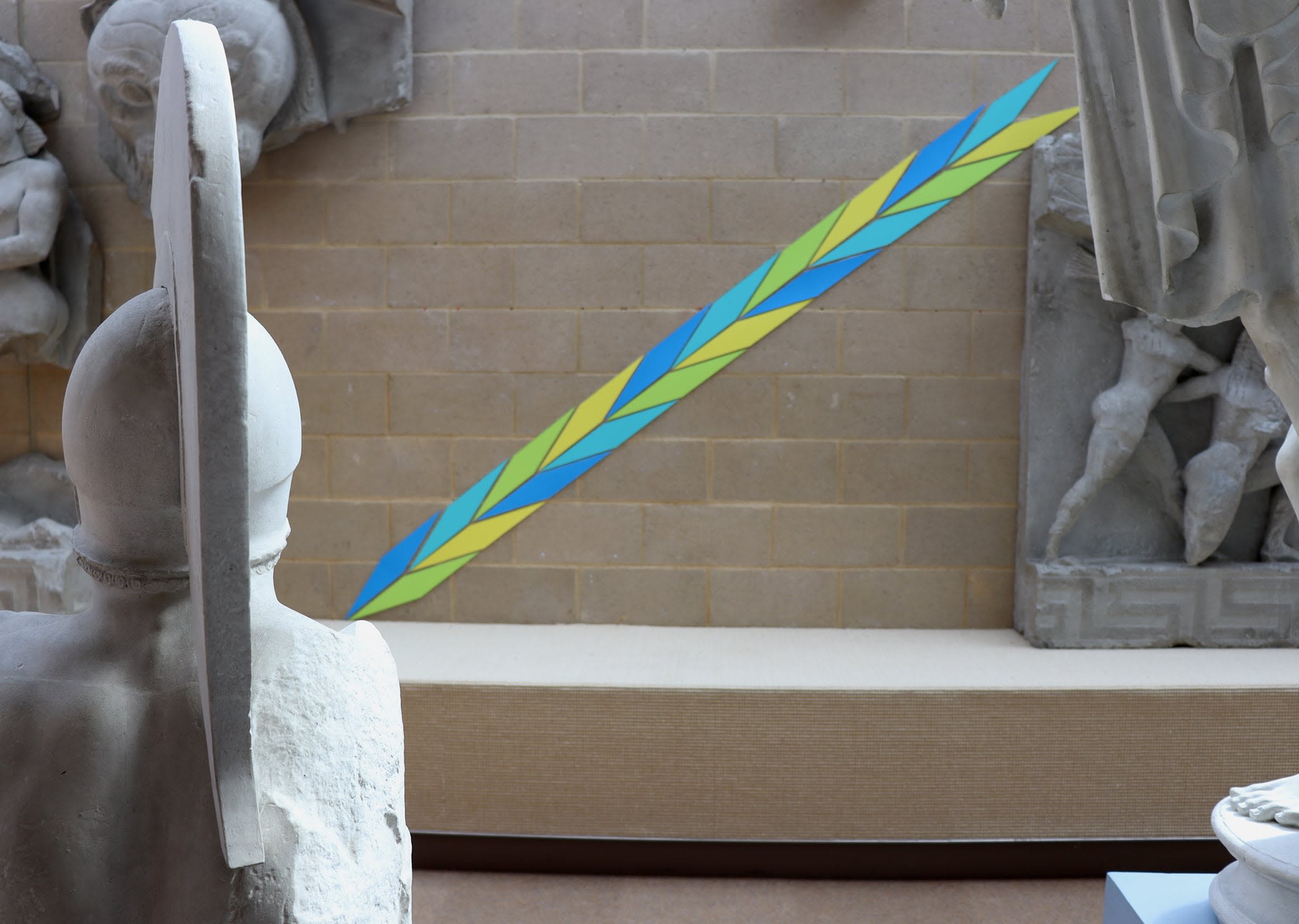 Breeze block wall with coloured mountboard placed in a diagonal pattern