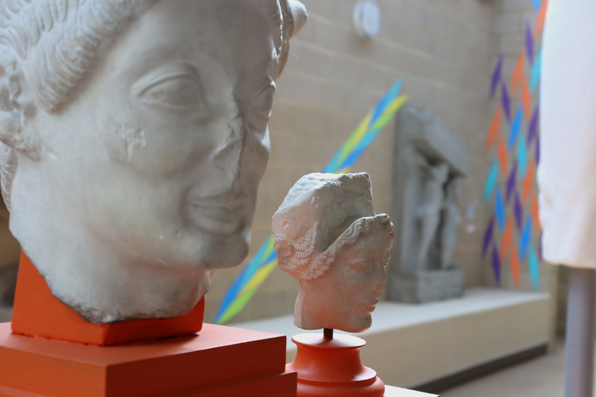 Sculpture with colourful diagonal mountboard pattern in foreground