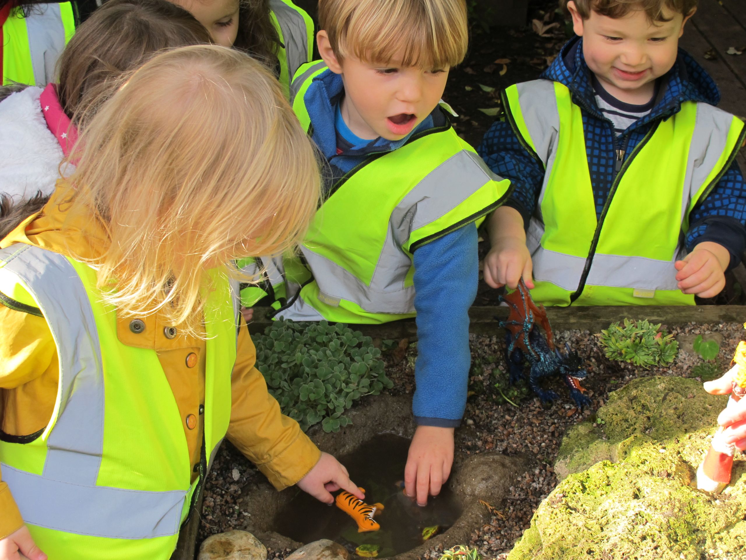 Three children investigating the Botanic Garden