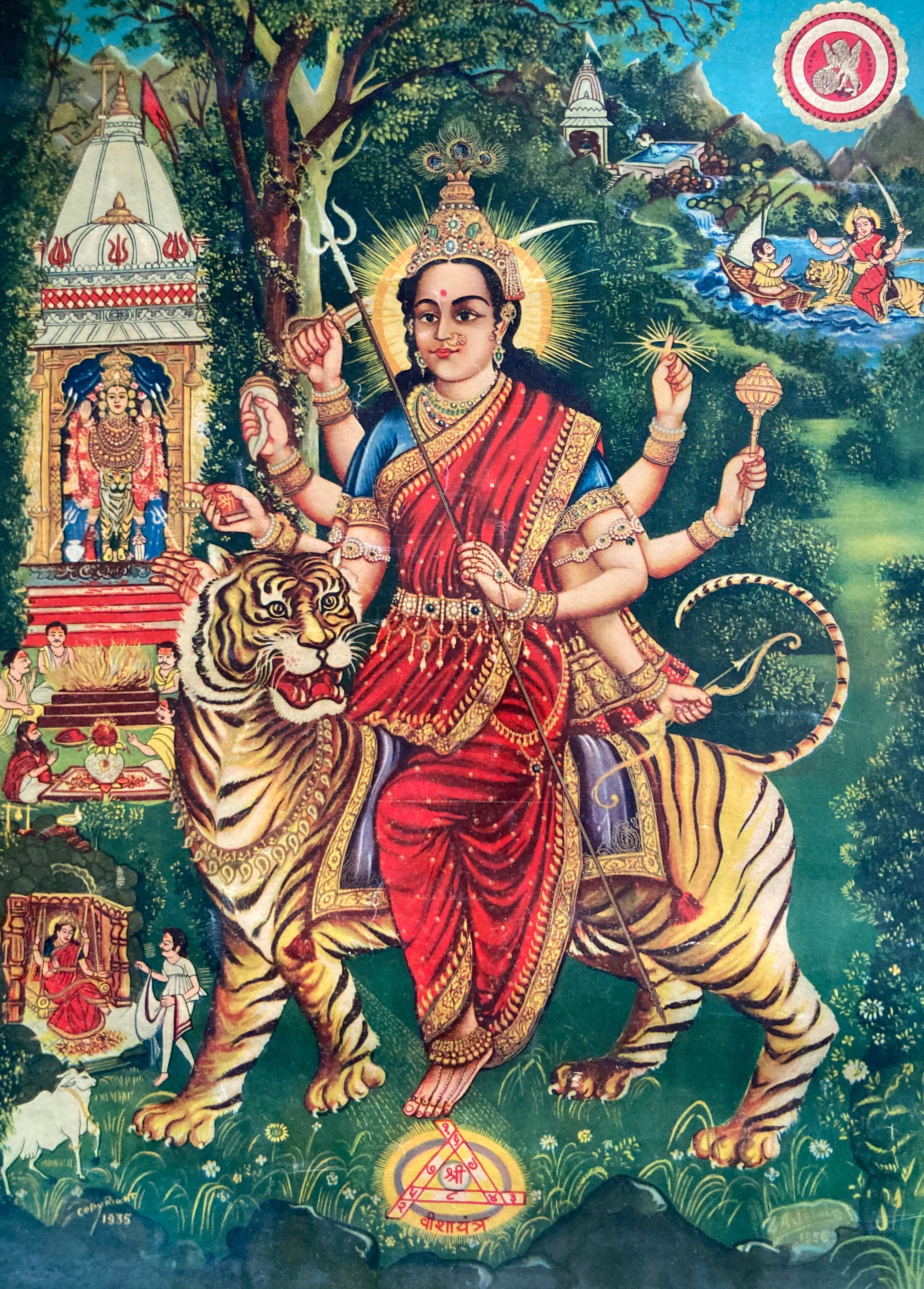 Colourful poster print showing a goddess wearing a red sari, with six arms and bangles on each wrist, holding various objects. She sits atop a tiger. The background is green and lush, with a temple visible on the left and a flowing river, with scenes from mythology, in the top right.