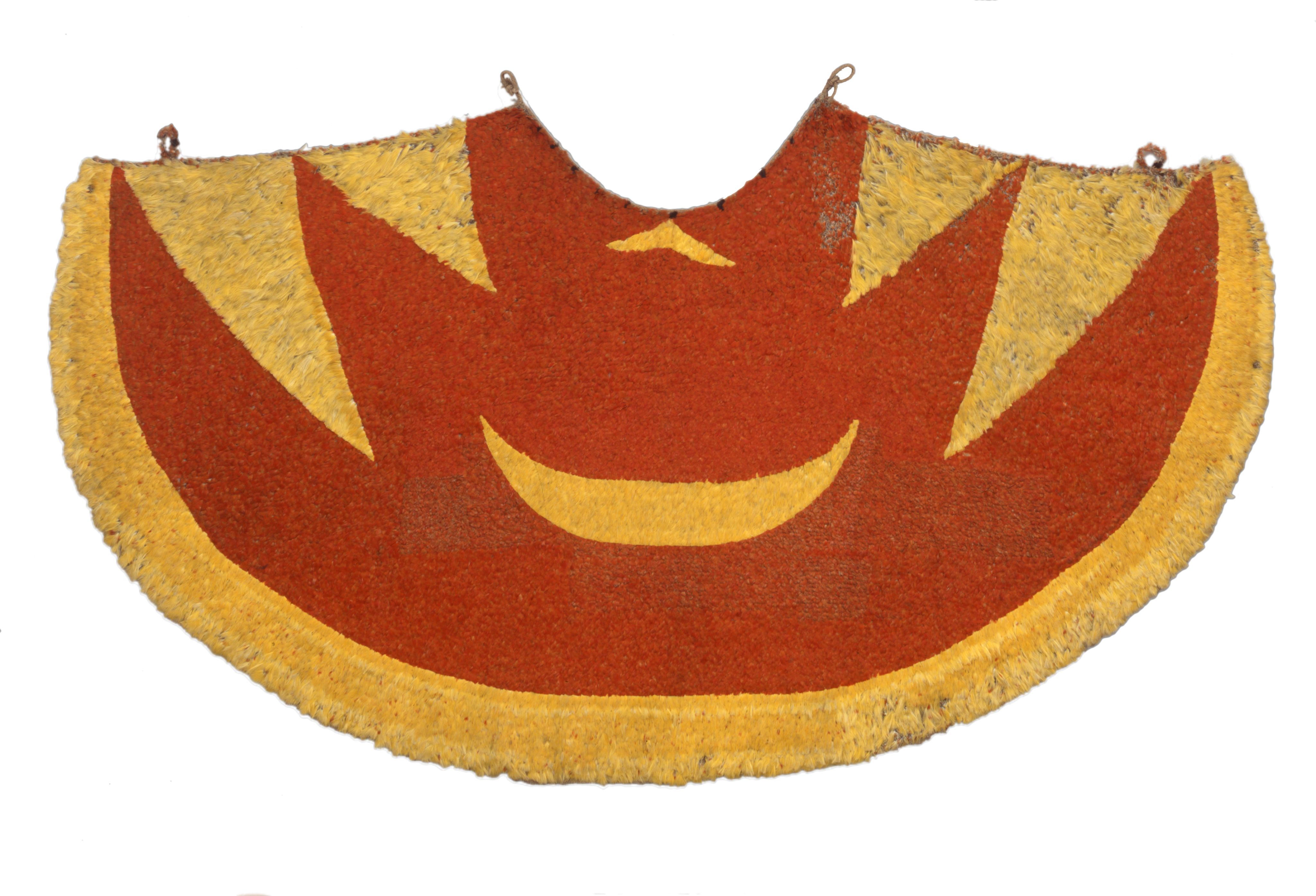 Full view of a large cloak, yellow and red, with a yellow stripe round the outside and angular sections around the top edge. Cape is mirrored in design, and laid flat against a white background for the photograph.