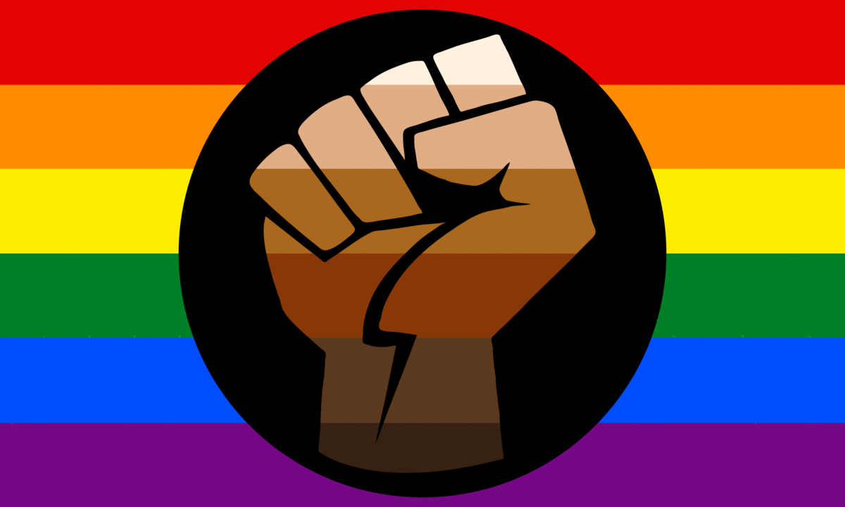Flag with six horizontal stripes: red, orange yellow, green, blue, purple. A circular logo of a clenched fist, with the stripes becoming shades of black and brown, sit over the centre.
