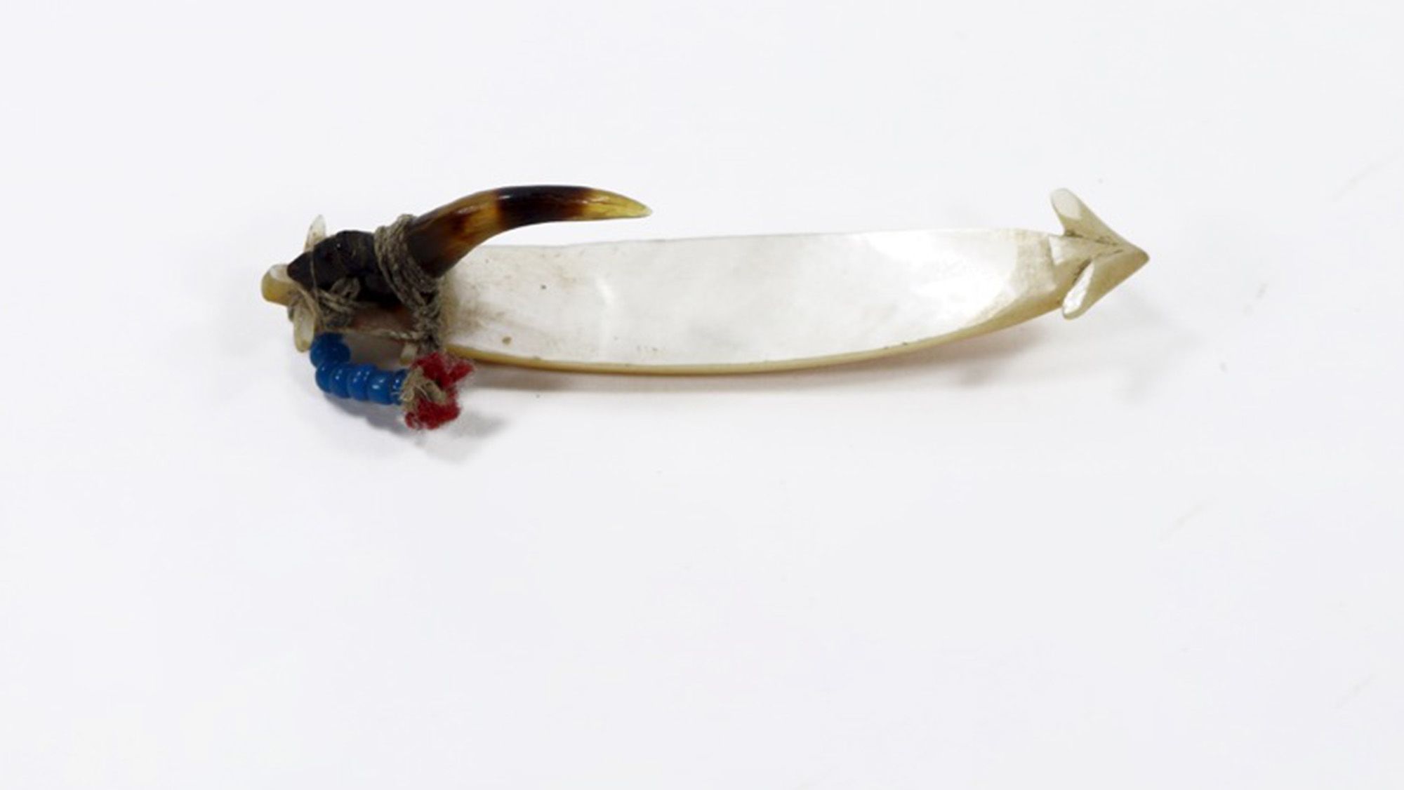Fish-hook formed of a shank of shell and point of turtle-shell, lashed together with plant fibre and provided with a hackle of blue bead and red cloth.