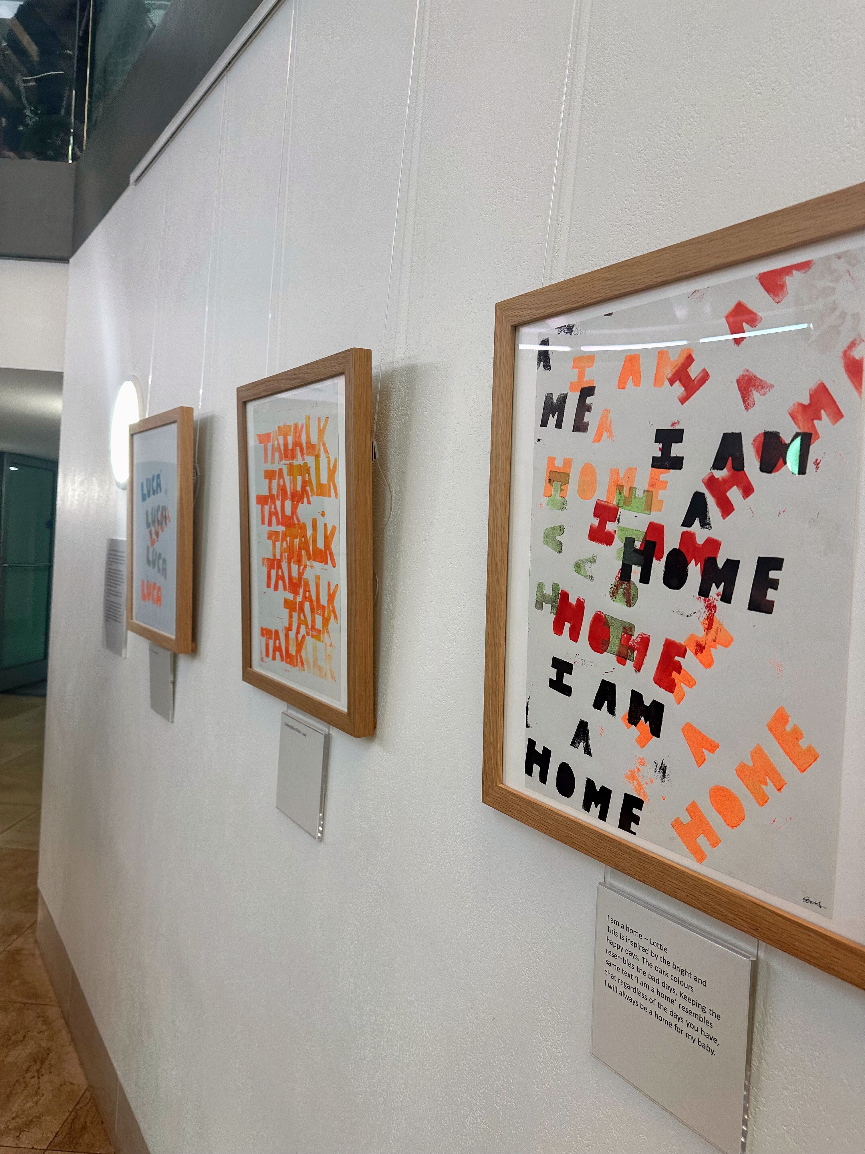 Three framed artworks with labels underneath at the Fitzwilliam, filled with brightly coloured text.